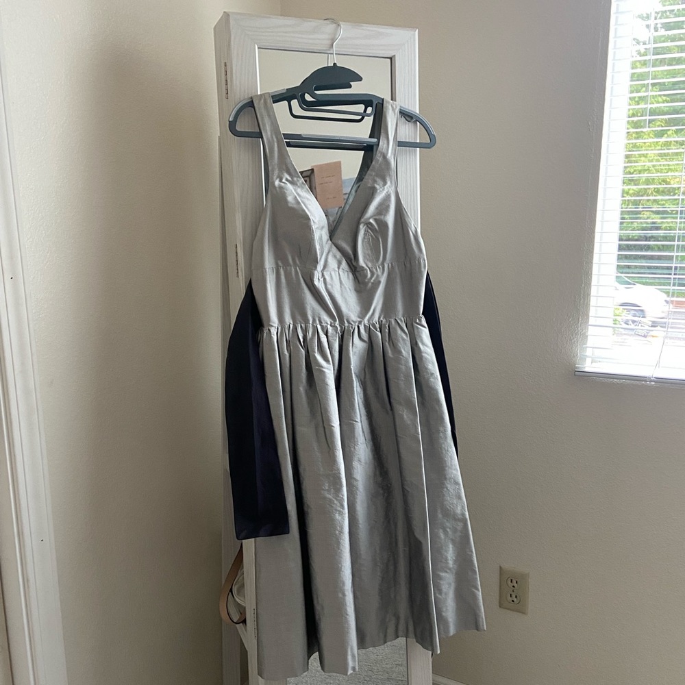 A midi dress in size 6 with a black tie in back, color: silver
